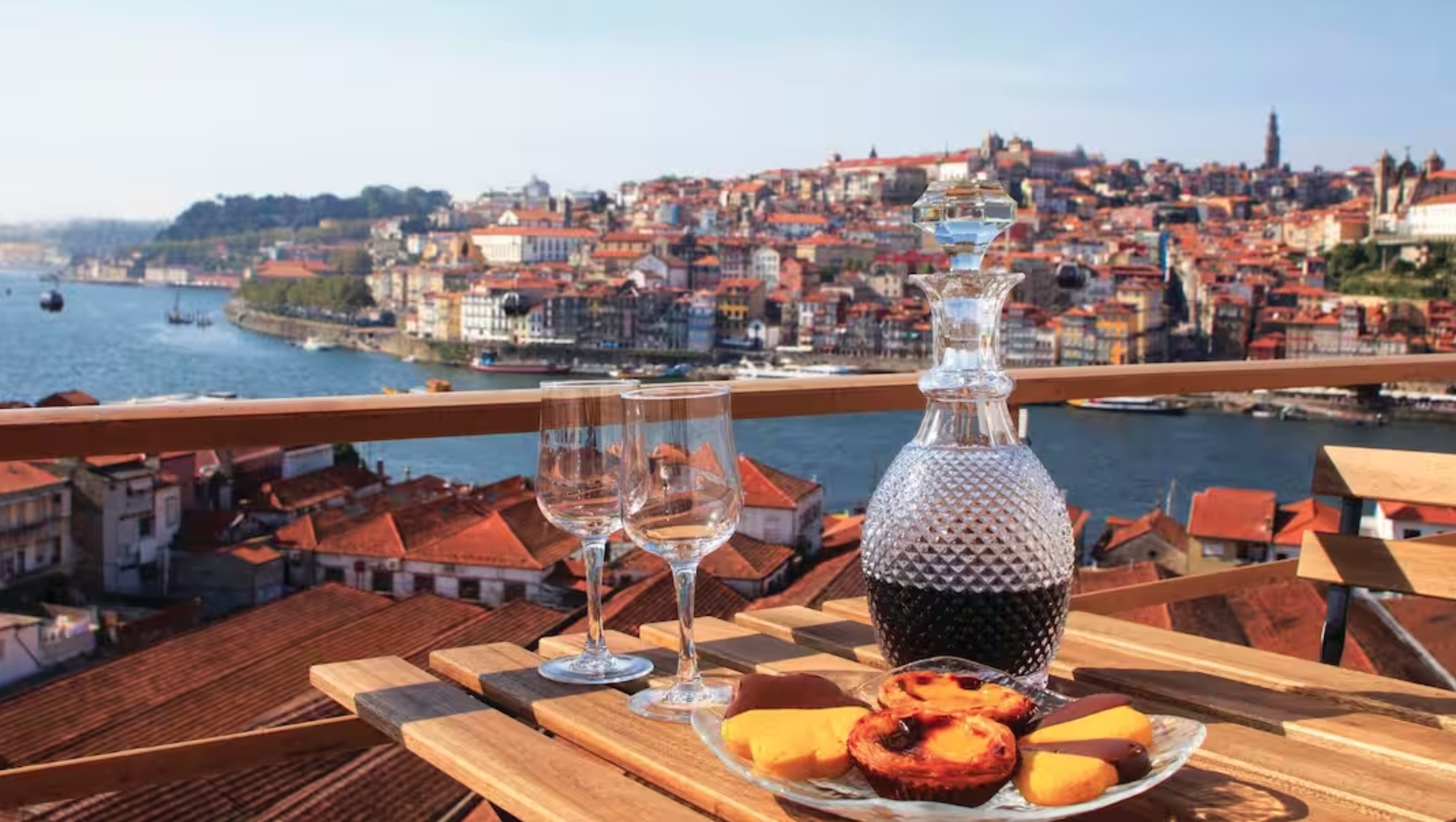 Bottle of port and glasses, looking over the Douro, Porto