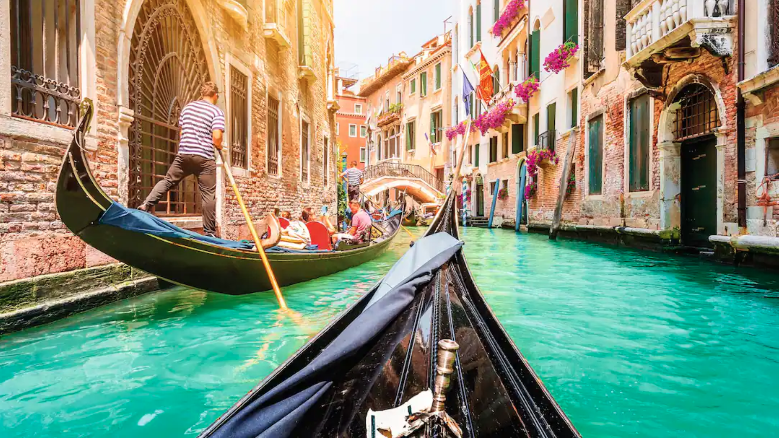Traditional gondolas on a narrow canal in Venice, Italy