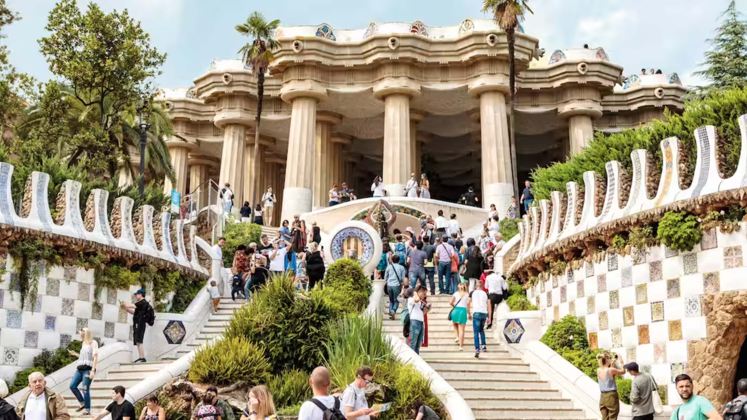 people walking up the steps in Parc Guell, Barcelona, Spain