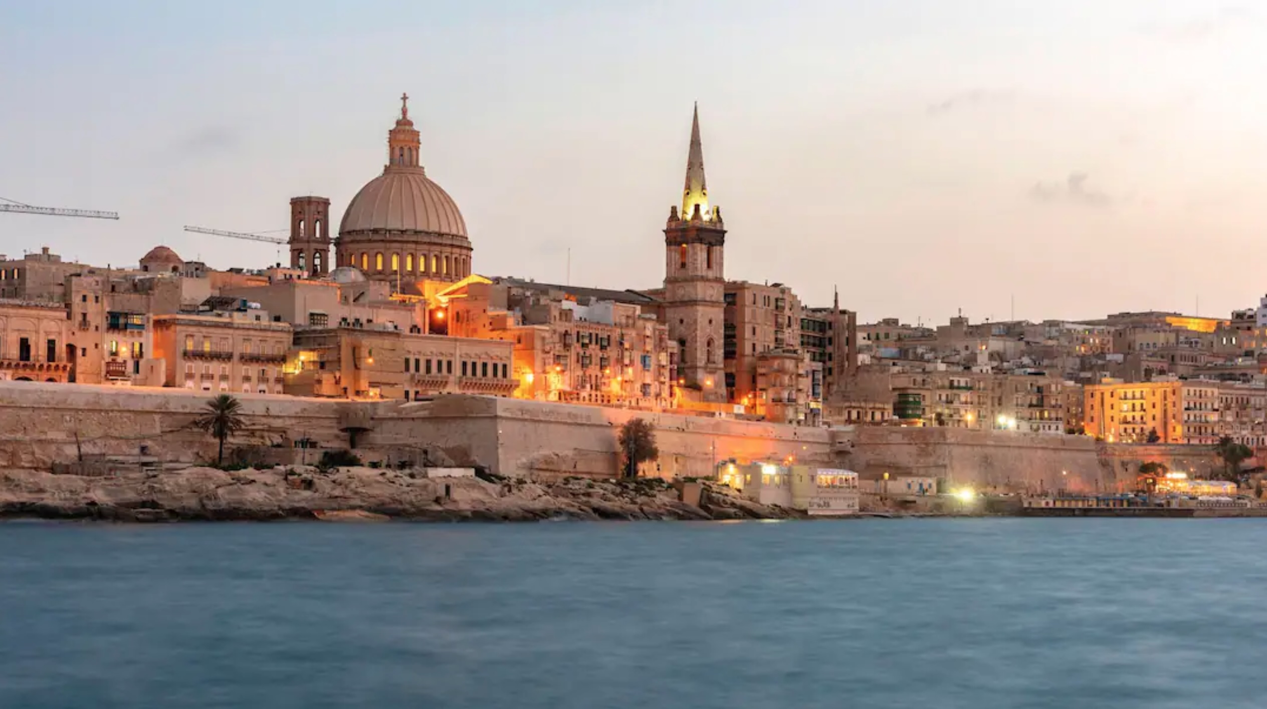 View of the city of Valletta from the sea at dusk